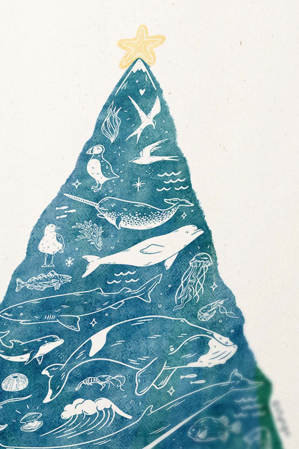 Close up of art print showing whales and star fish on top of a christmas tree